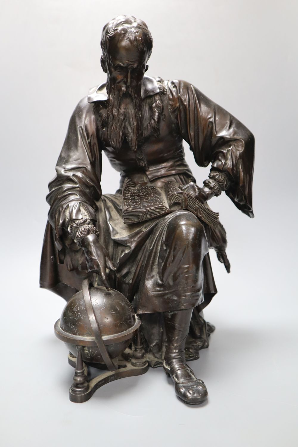 Jean Gout. A bronze model of a scholar painting to a globe, height 34cm